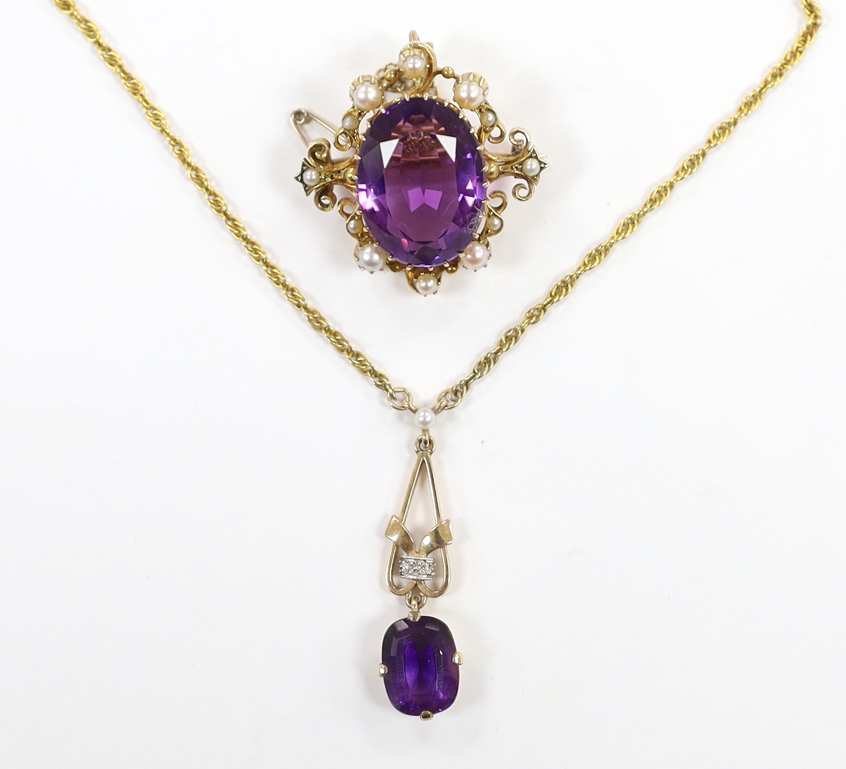 A 1960's 9ct gold, amethyst, seed pearl and diamond chip set drop pendant, 35mm, on a 9ct gold chain, 40cm and a yellow metal, amethyst and seed pearl set oval brooch, gross weight 16.5 grams.